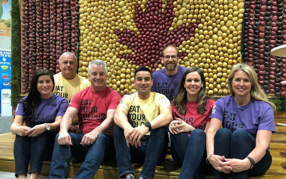 team in front of potato wall